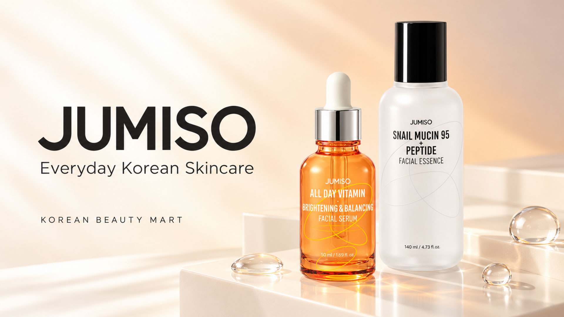 Jumiso Snail Mucin essence with a black cap beside an orange All Day Vitamin serum dropper bottle on an ivory and pale apricot background.