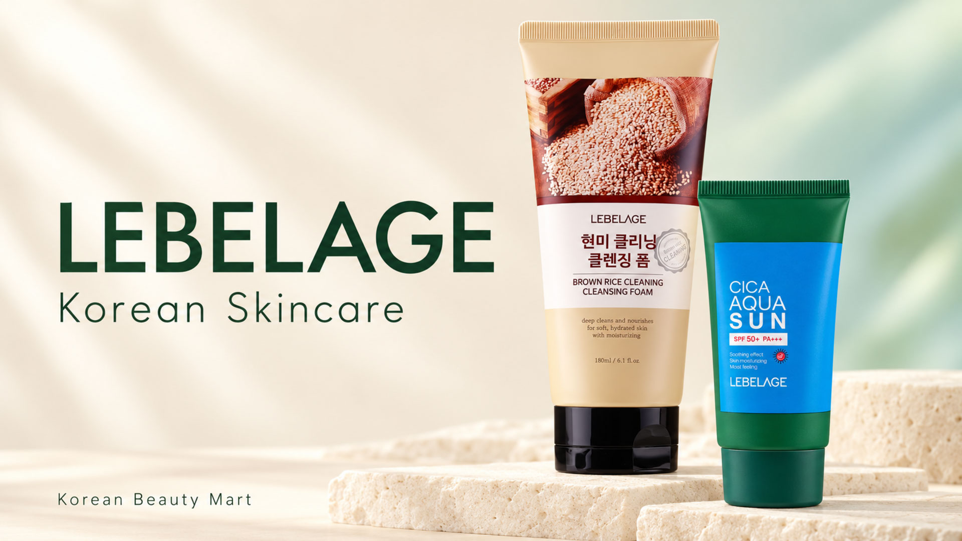 LEBELAGE beige Brown Rice Cleansing Foam tube and green-and-blue Cica Aqua Sun tube on an ivory and sage studio background.