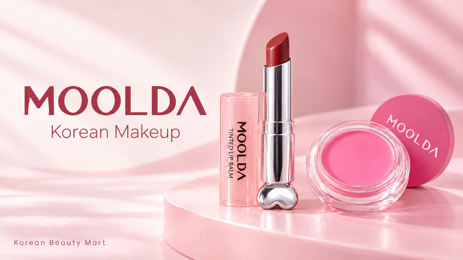 MOOLDA Dry Rose LB10 tinted lip balm and Frozen Pink 09 blush on a pale pink Korean Beauty Mart banner